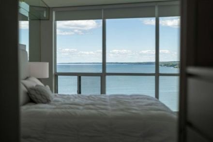 Sample listing: a bedroom with a large window looking out over the ocean